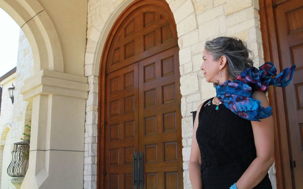 Esther stands in front of church as she recalls her faith